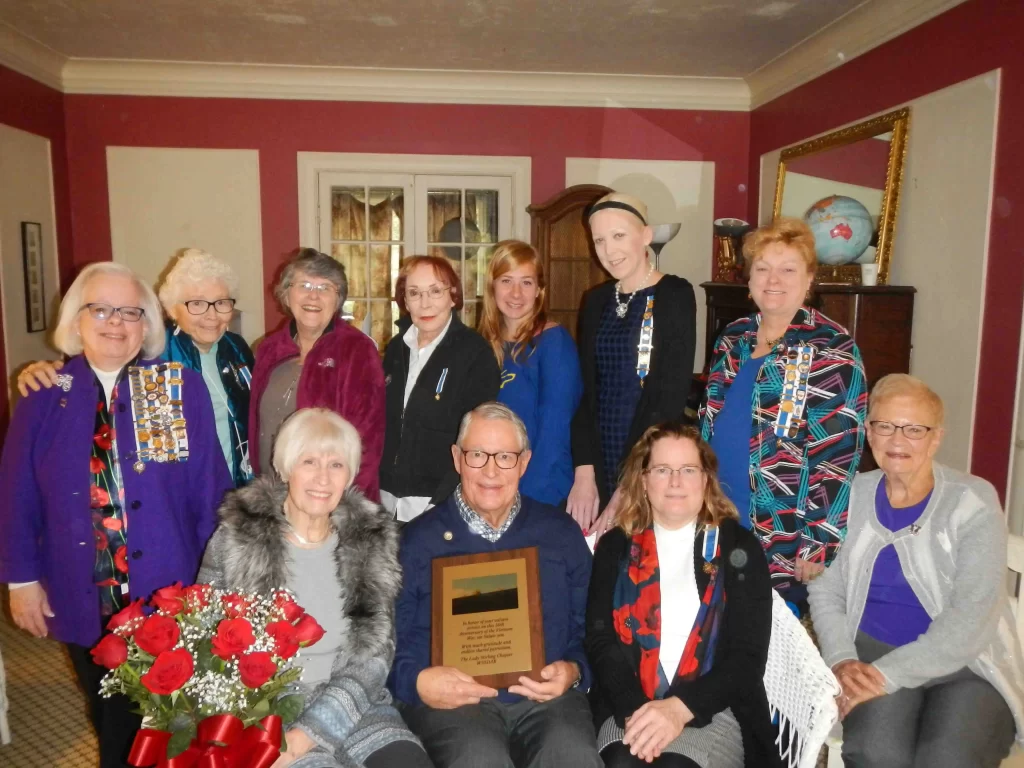 Members Honoring veterans with a plaque and having a tea party.